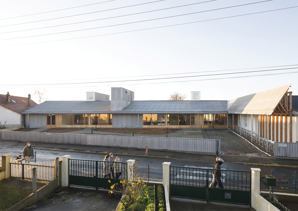 Main entrance set back from the street and the new paved forecourt